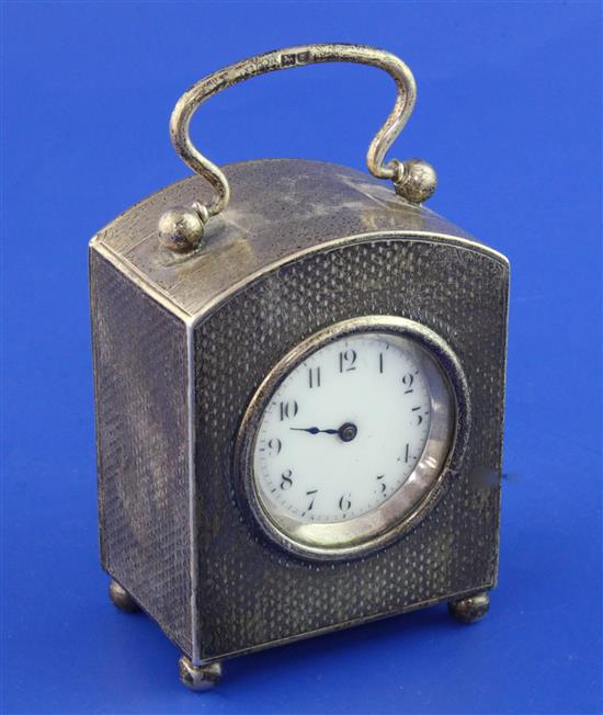 An Edwardian engine turned silver cased carriage timepiece by the Goldsmiths & Silversmiths Co Ltd, 3.5in excluding handle.